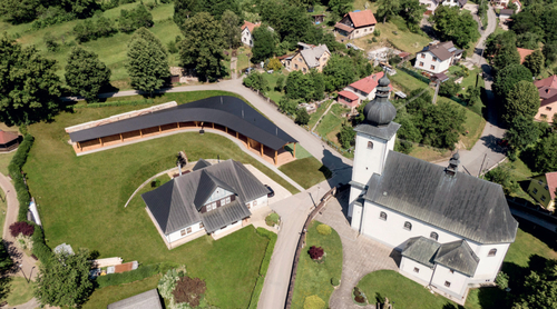 Farní areál v Lidečku v leteckém pohledu; odtržení staveb umožňuje jejich využívání nezávisle na sobě, zároveň tvoří kompaktní celek.